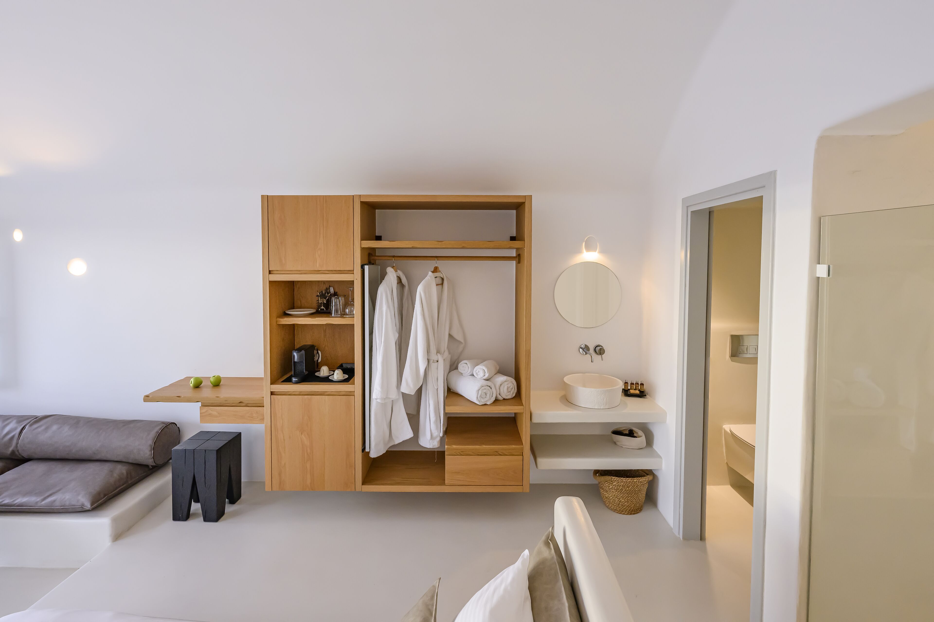 A modern bathroom with a wooden vanity, a mirror, and a sink.