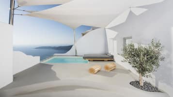 Relax by the infinity pool overlooking the ocean with a comfortable seating area and lush greenery nearby.