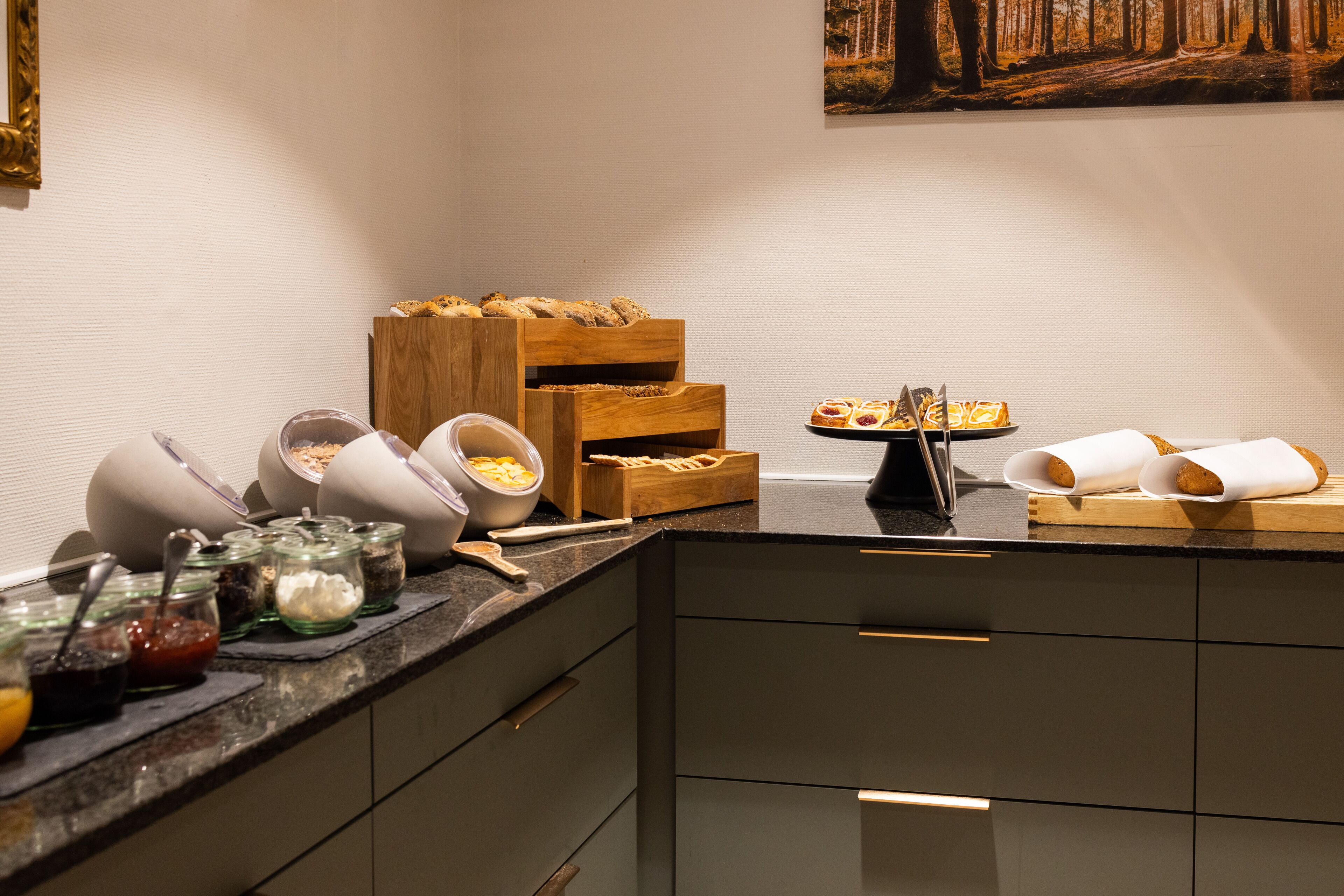 A breakfast buffet setup with various food items and condiments.