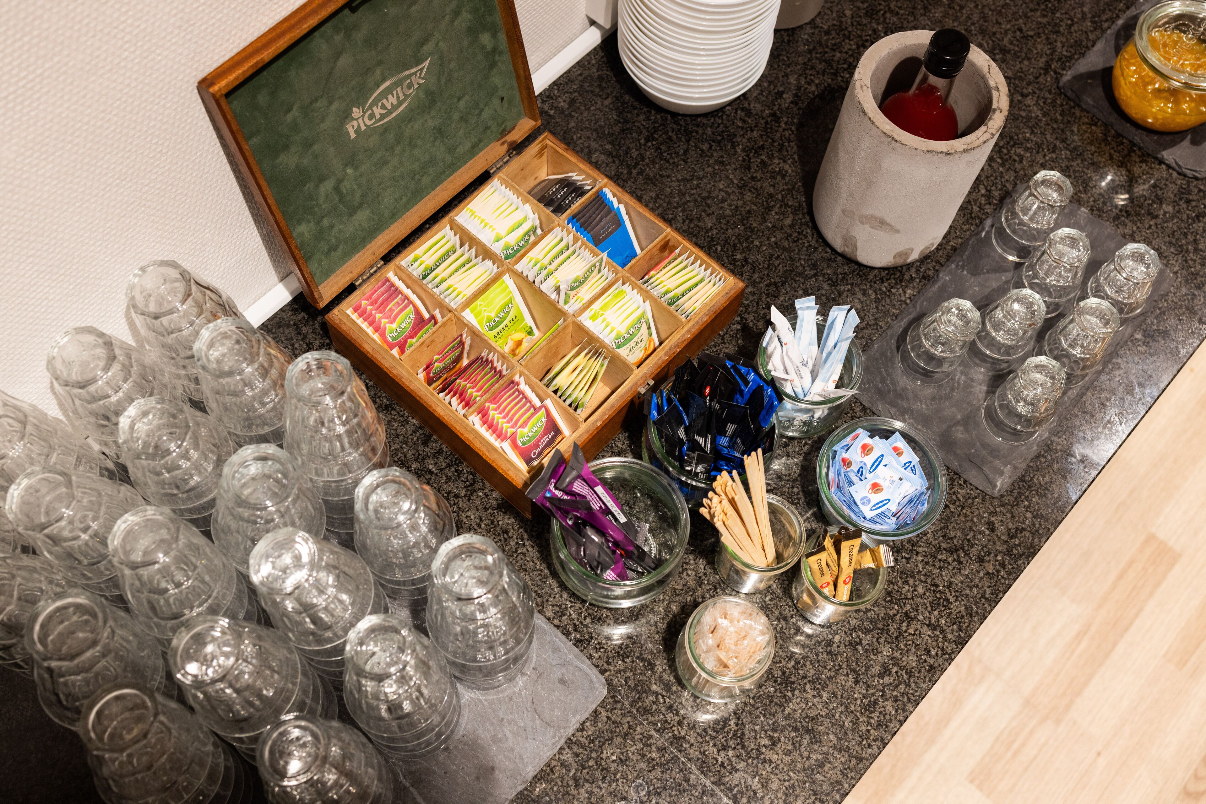 A buffet setup with various food items and condiments.