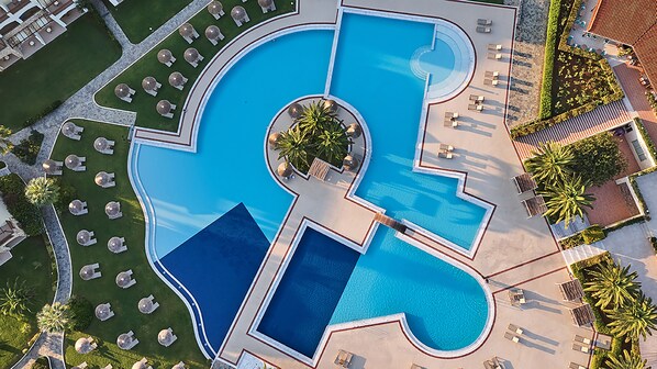 Una piscina techada, 4 piscinas al aire libre, sombrillas