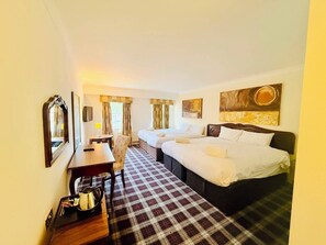 A hotel room with two beds, a desk, a chair, a table with a kettle, and a check-in trolley. - Wrexham Llyndir Hotel by Belvilla (Wrexham)