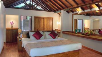 A bedroom with a wooden bed, a nightstand, a mirror, and a wooden wardrobe.
