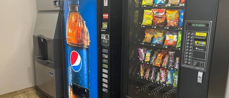 A vending machine with a Pepsi advertisement and a selection of snacks.