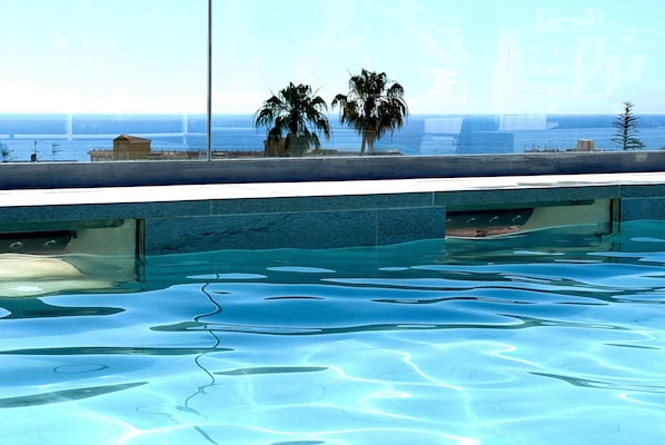 Outdoor pool, open 11:00 AM to 7:00 PM, sun loungers