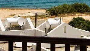 A coastal view with a beach and a boat in the distance. - Anais Bay Hotel (Paralimni)