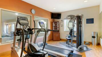 A gym with treadmills, ellipticals, and weight machines.