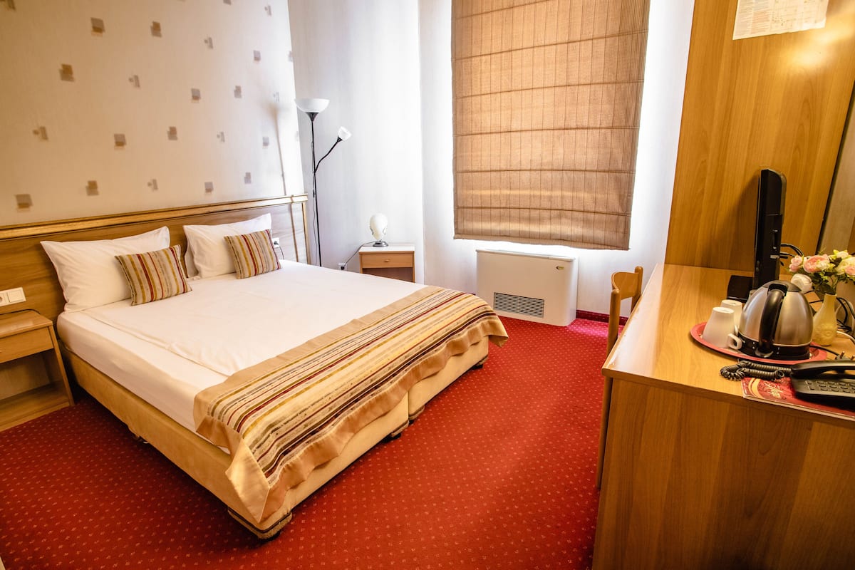 Economy Double Room | Minibar, in-room safe, iron/ironing board (on request), WiFi (free)