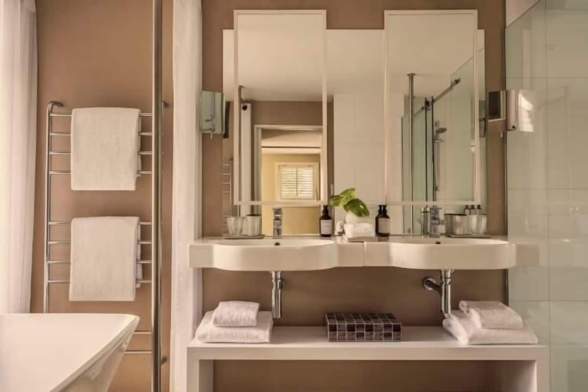 Separate bathtub and shower, deep-soaking bathtub, designer toiletries