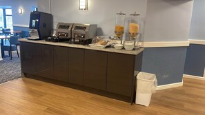 A reception area with a dark wooden counter, coffee machines, and two glass dispensers with grains. - Britannia Hotel Wigan, Standish M6 J27 (Wigan)