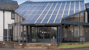 A modern building with a reception area, large glass windows, and a sloped roof. - Britannia Hotel Wigan (Wigan)