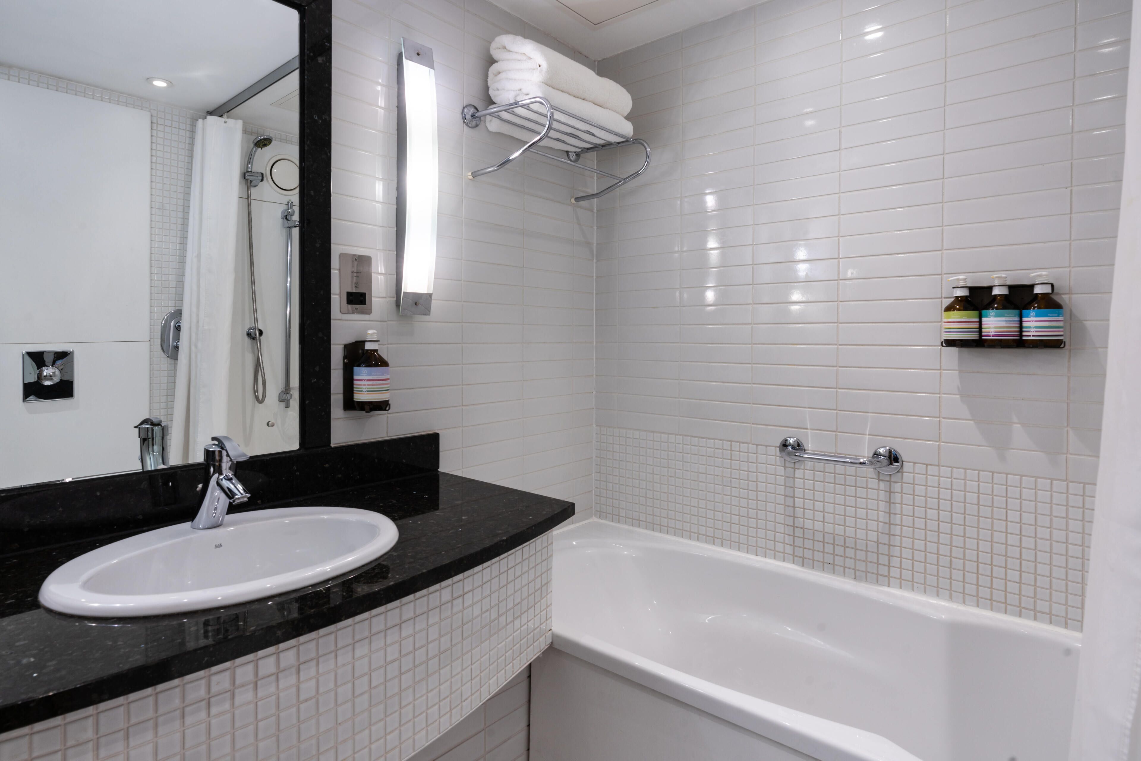 designer toiletries, hair dryer, towels, soap