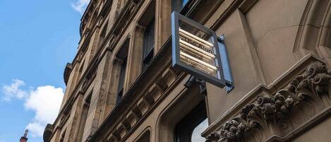 A building with a sign that reads "The Alan 18 Princess St."