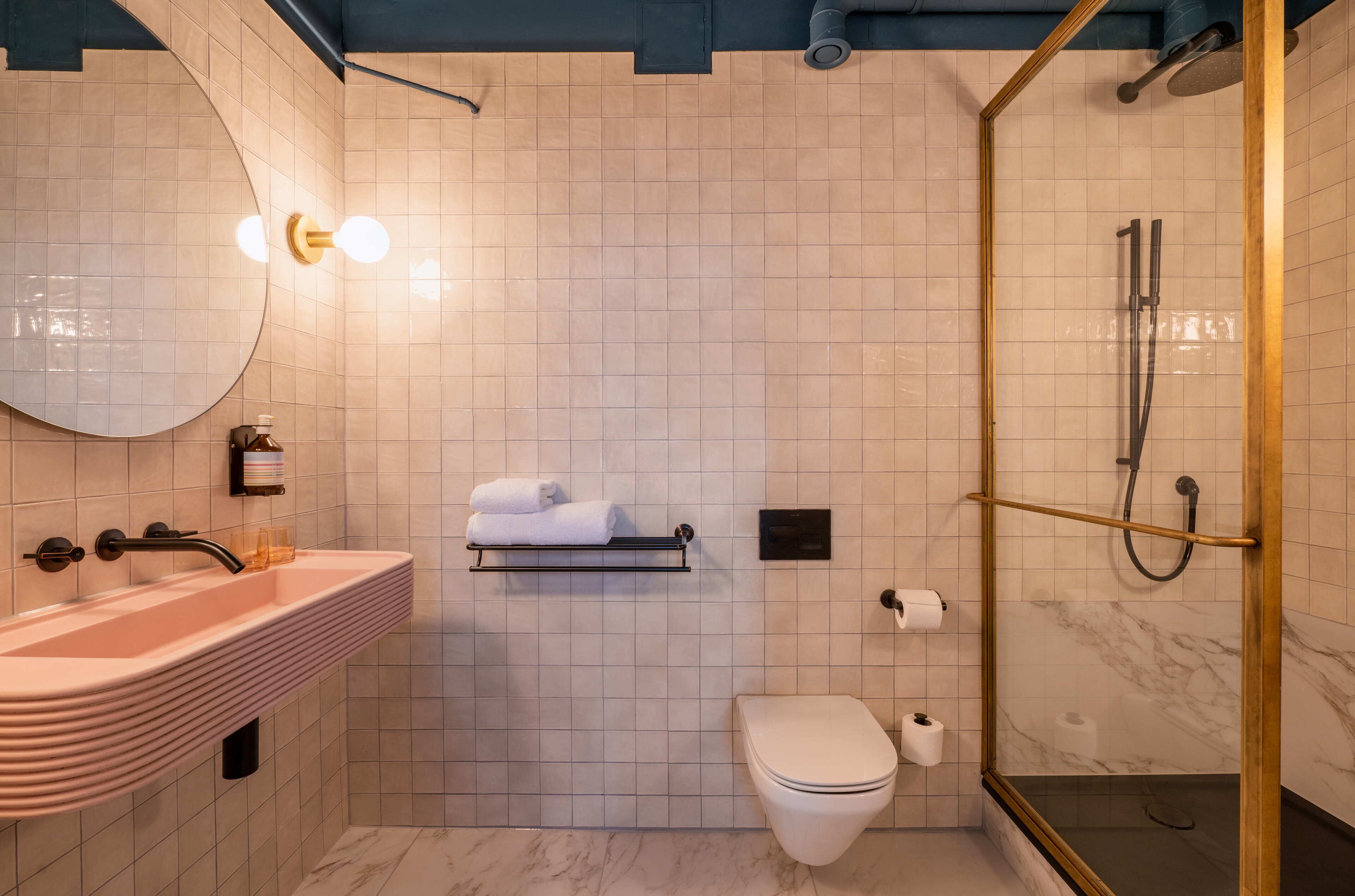 signature deluxe | bathroom | designer toiletries, hair dryer, towels, soap