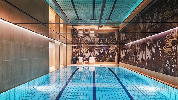 A modern indoor swimming pool with blue tiles, a tropical mural on the walls, and a clean, minimalist design. - Hôtel Barrière Le Westminster Le Touquet (Le Touquet-Paris-Plage)