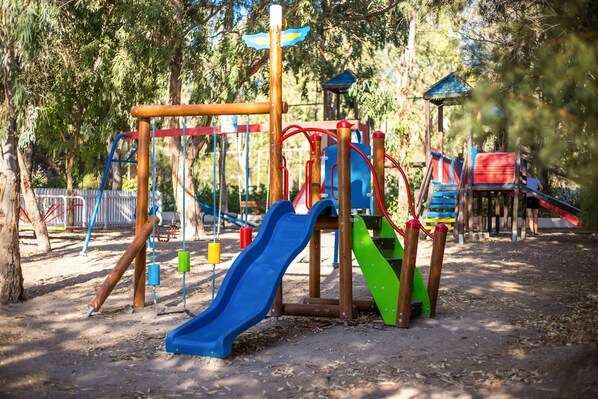 A playground with various play structures including slides and swings. - Pegasos (Rhodes)