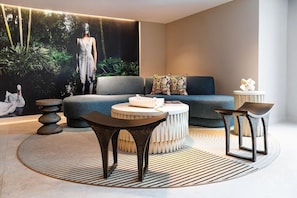 A modern living room with a sofa, coffee table, and side tables. - Sanctuary South Beach (MIAMI BEACH)