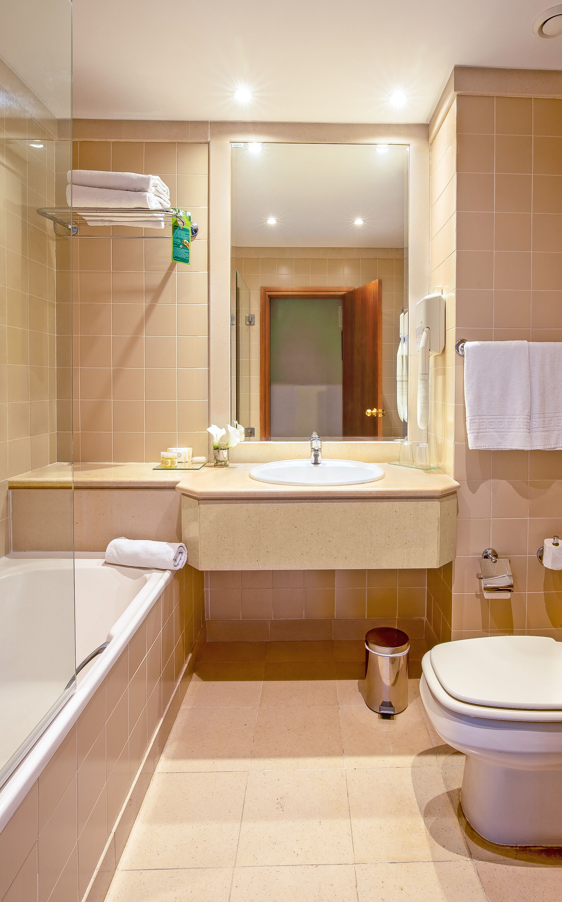 A modern bathroom with a bathtub, sink, and toilet.