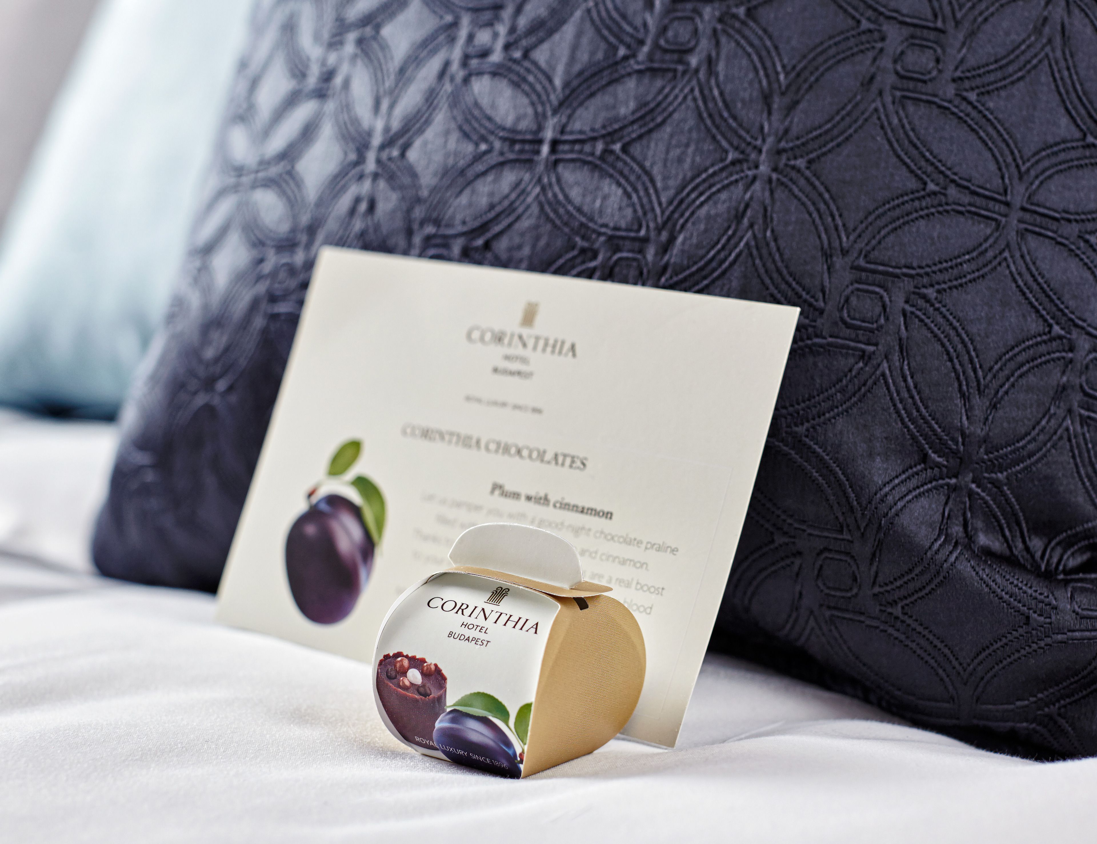 A brochure for Corinthia Hotel Budapest, featuring a chocolate dessert.