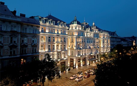 A large, historic hotel with multiple stories, ornate architecture, and a prominent dome.