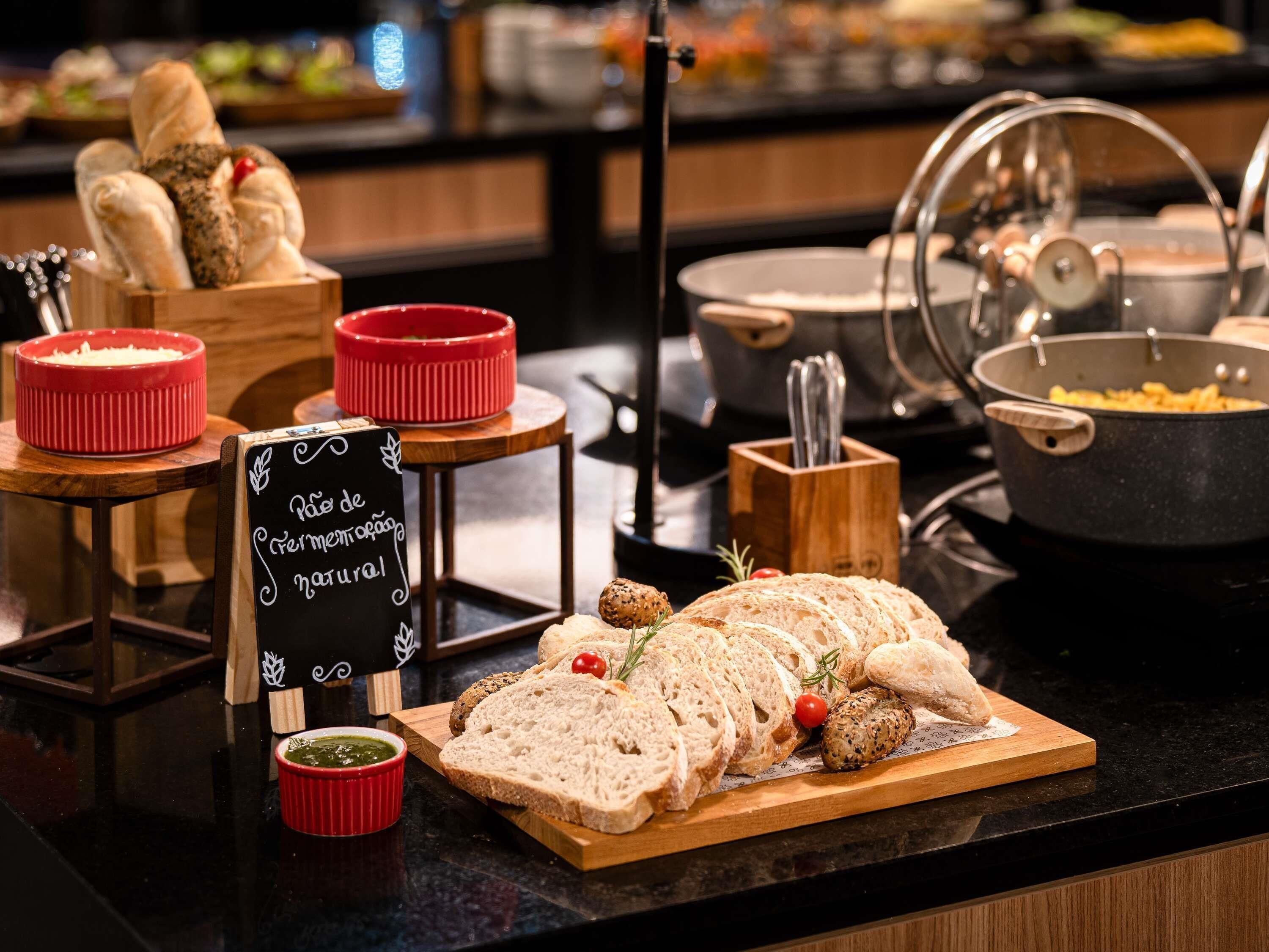 A buffet setup with various food items and a sign indicating a natural menu.