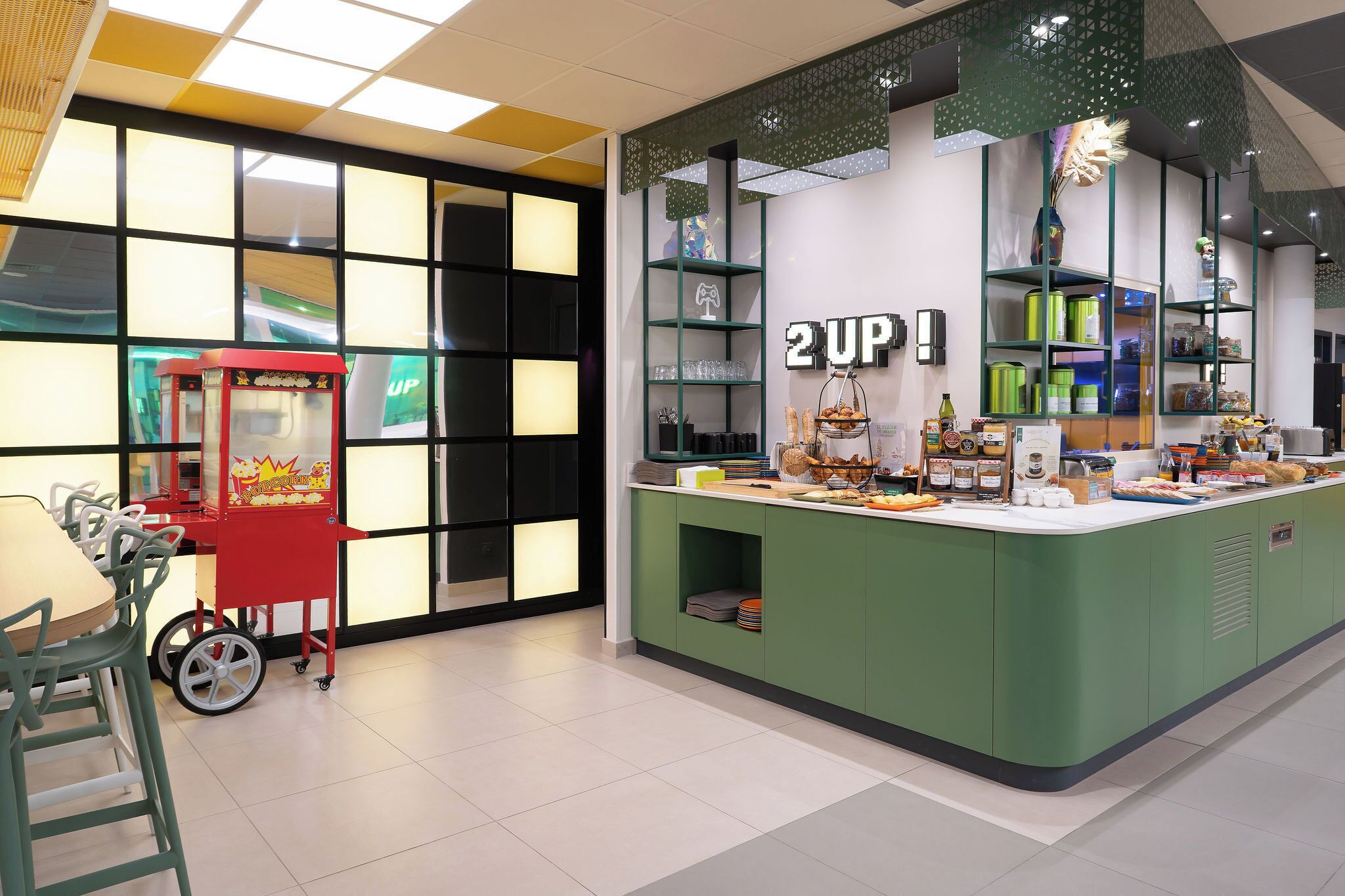 A counter with a green cabinet, a red vending machine, and shelves with various items.