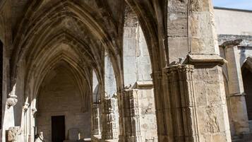 A cathedral's interior with a long, arched corridor and stone columns.