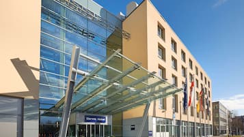 Reflecting the sky with a striking glass facade, the Dorint Hotel presents a modern entrance.