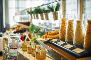 A breakfast buffet with various food items and condiments. - Dorint Hotel am Dom Erfurt (Erfurt)