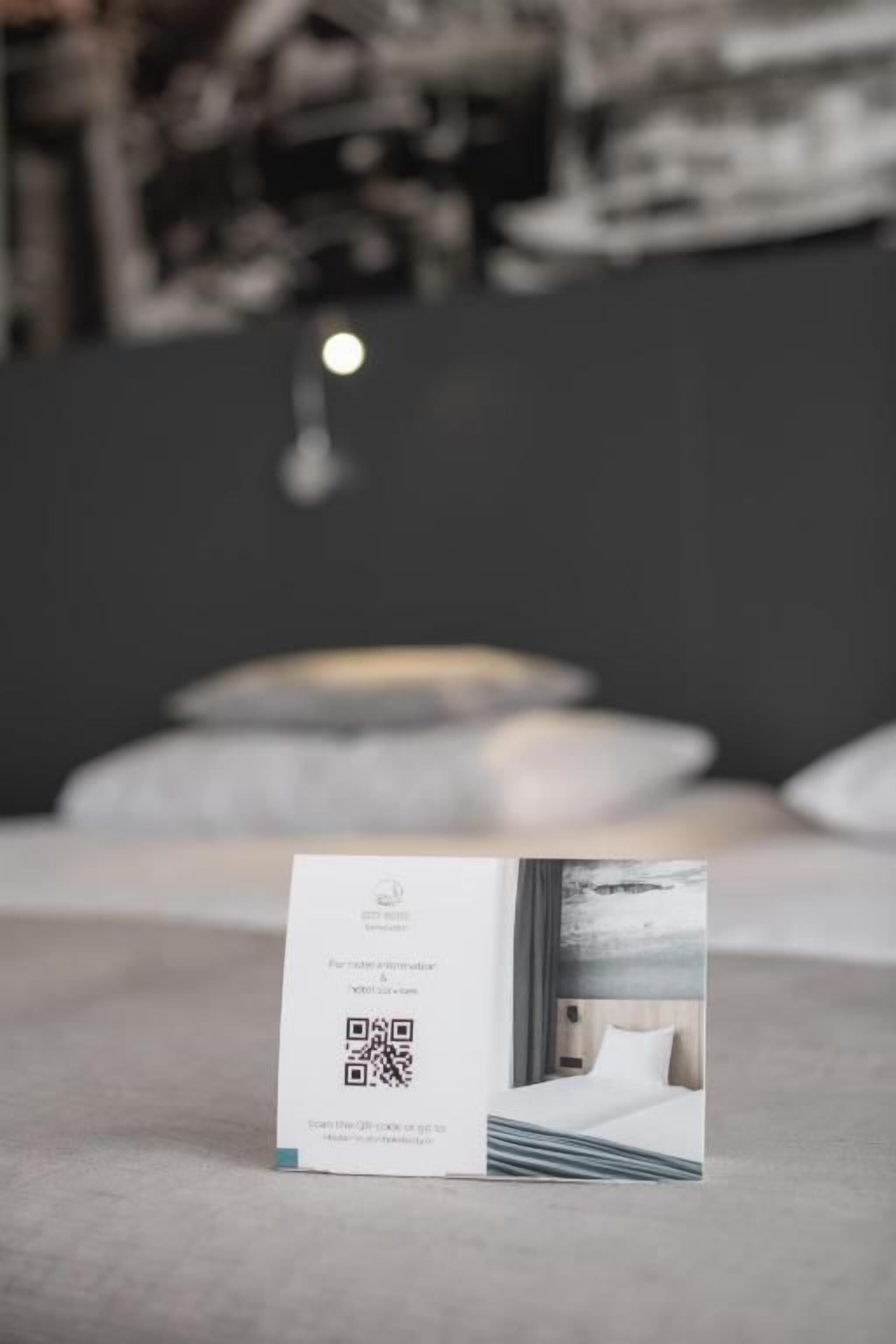 A brochure on a table with a QR code, a QR code, and a QR code.