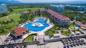A resort with a central swimming pool, multiple guest buildings, and a surrounding landscaped area. - Samba Vallarta - All Inclusive (Nuevo Nayarit)