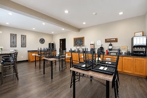 A restaurant with a bar area, wooden flooring, and a chalkboard menu. - Fairbridge Inn & Suites Williston Near Airport (Williston)