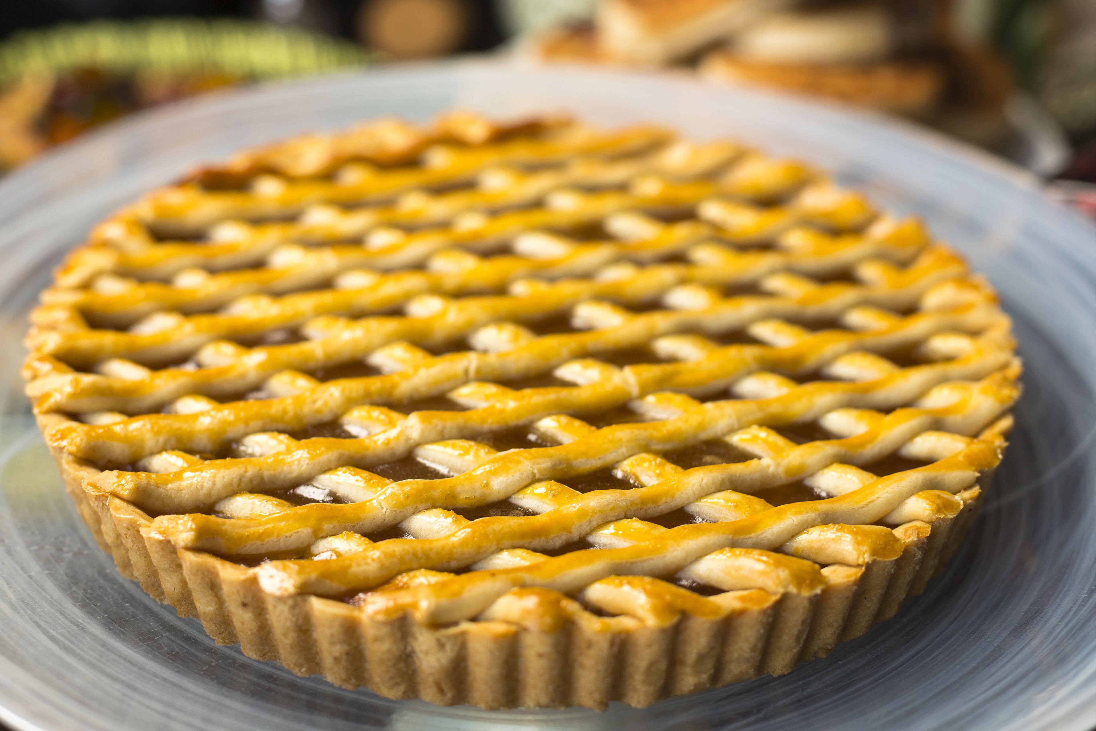Una torta con copertura a griglia su un piatto di vetro trasparente.