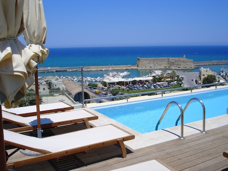 Seasonal outdoor pool, open 8:00 AM to 7:00 PM, pool umbrellas. GDM Megaron Historical Monument Hotel