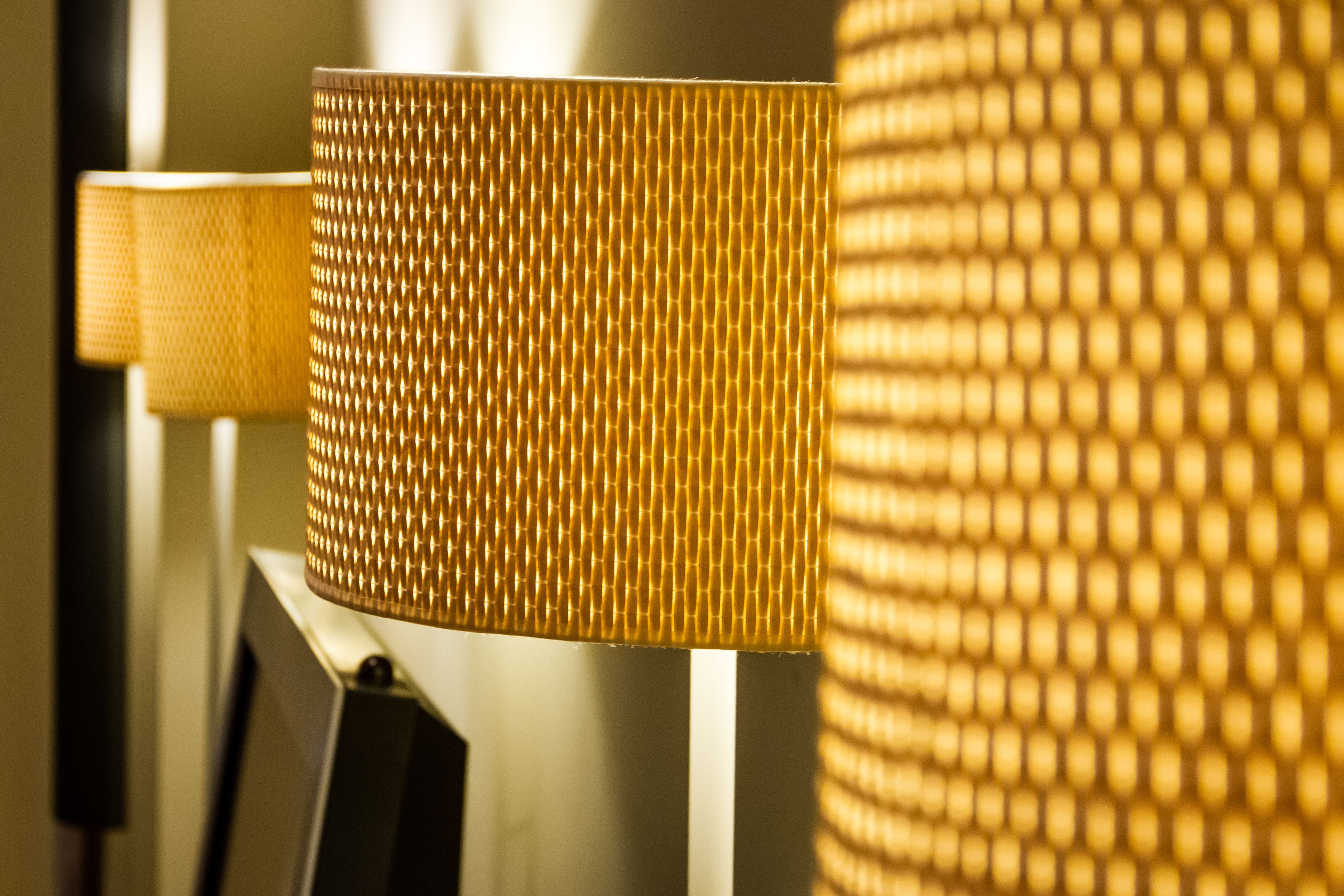 A close-up of a lamp with a textured, golden-colored shade.