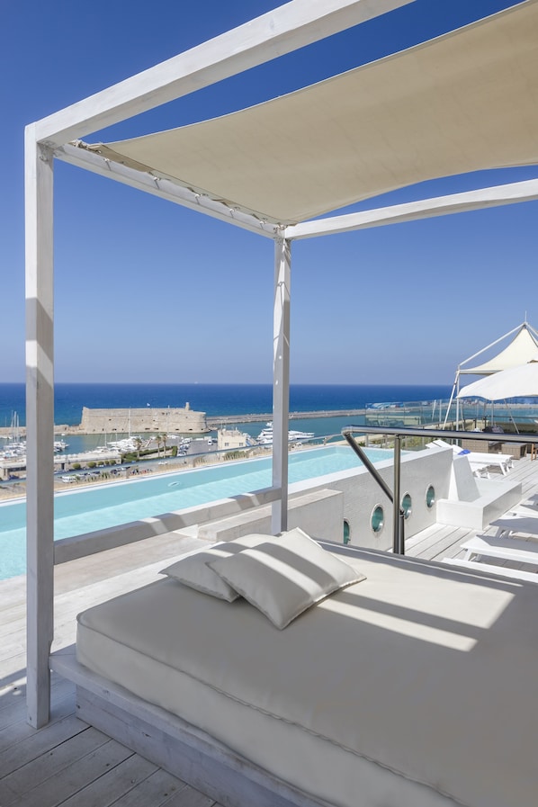 Seasonal outdoor pool, open 8:00 AM to 7:00 PM, pool umbrellas