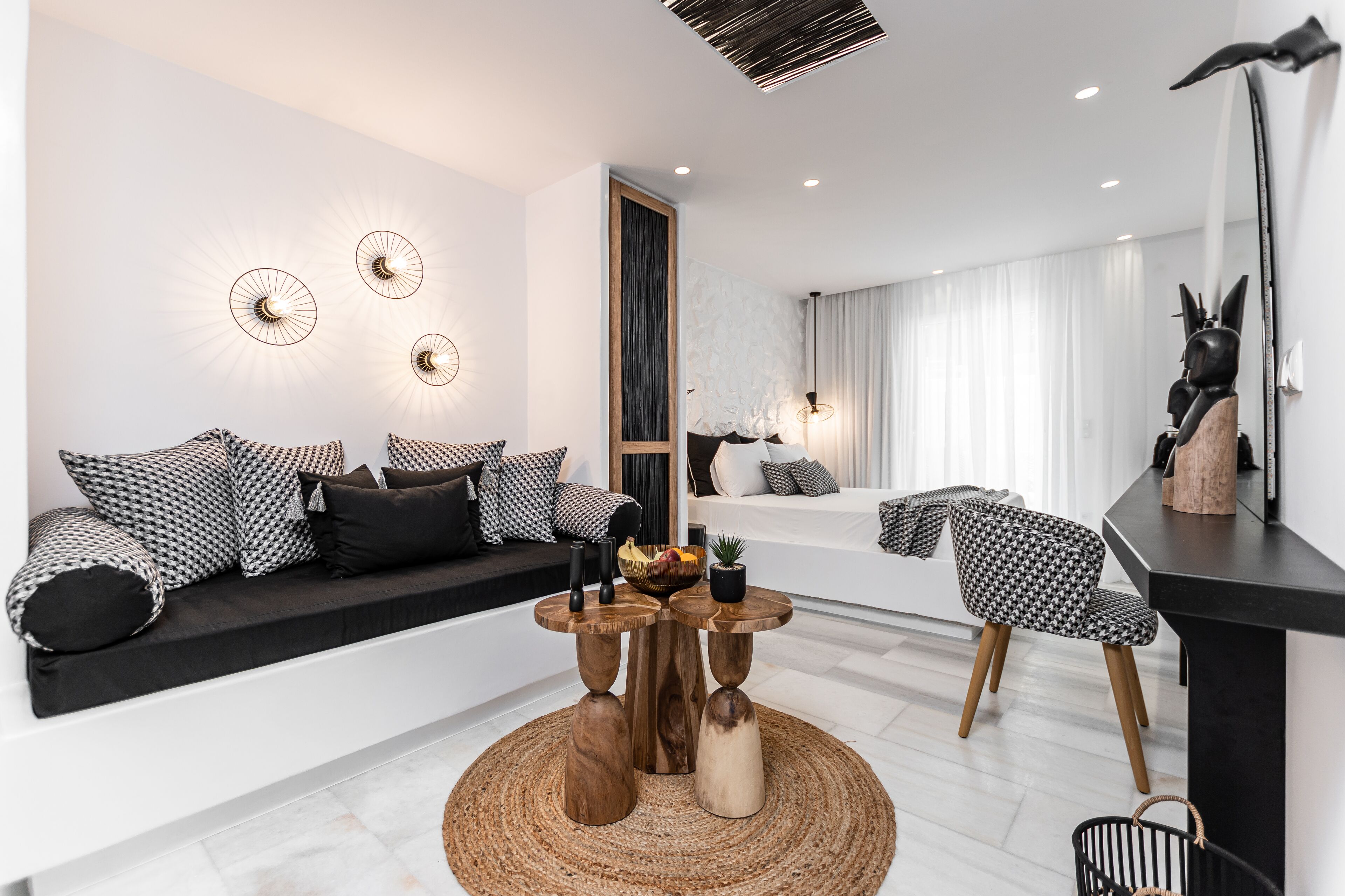 A modern living room with a sofa, two wooden tables, and a chair.