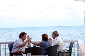 Enjoy a casual meal on the deck with a view of the sea.