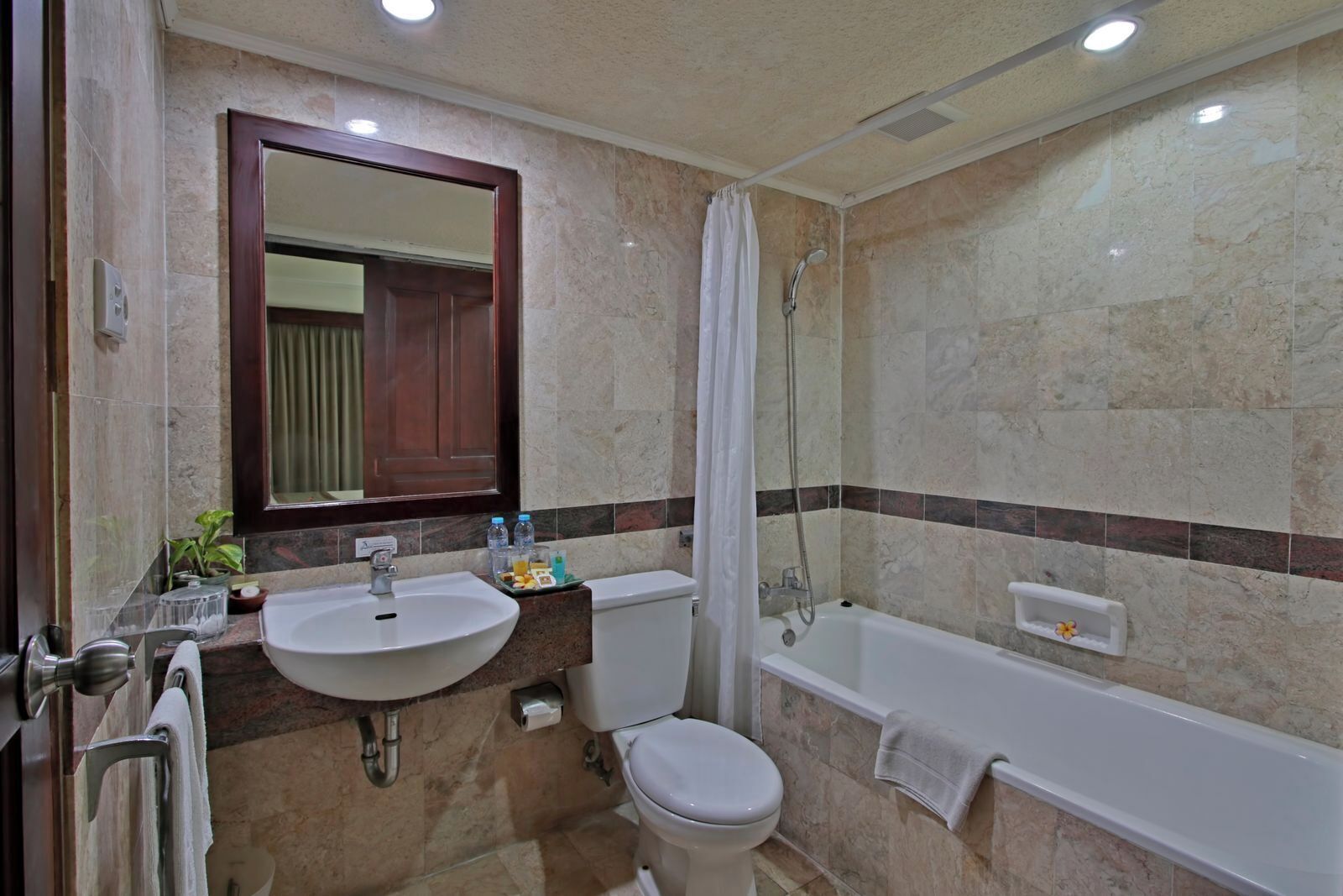 A bathroom with a sink, toilet, and bathtub.