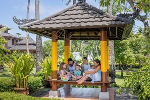 A gazebo with a tiled roof and a bench. - The Jayakarta Bali (Legian)