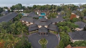 A resort with multiple buildings, a central pool, and a view of the ocean. - The Jayakarta Bali (Legian)