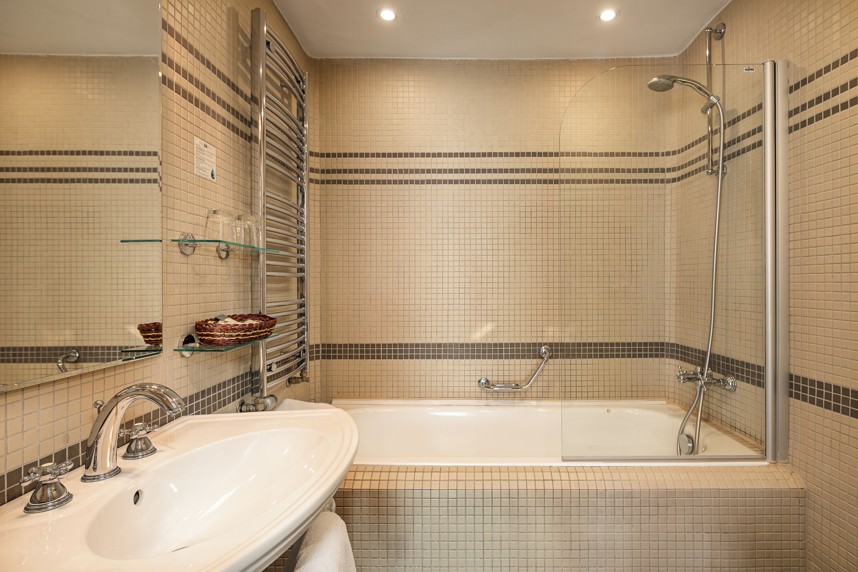 A bathroom with a sink, bathtub, and shower.