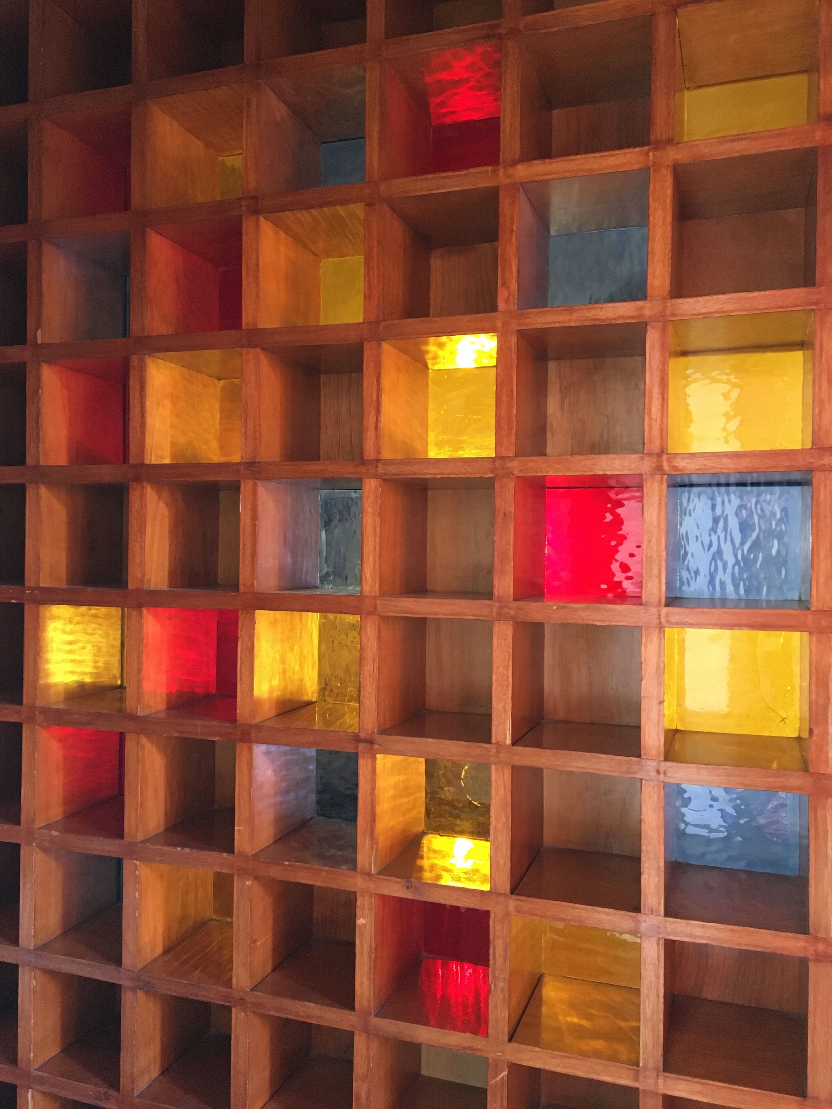A wooden grid structure with multiple empty compartments.