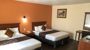 A hotel room with two beds, a desk, and a nightstand. - Turtle Bay Lodge (Redding)