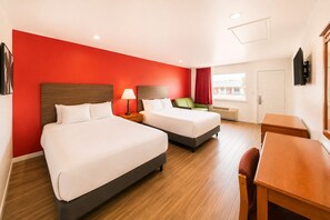 A hotel room with two beds, a desk, and a chair. - OYO Hotel San Antonio Near At&t Center (San Antonio)