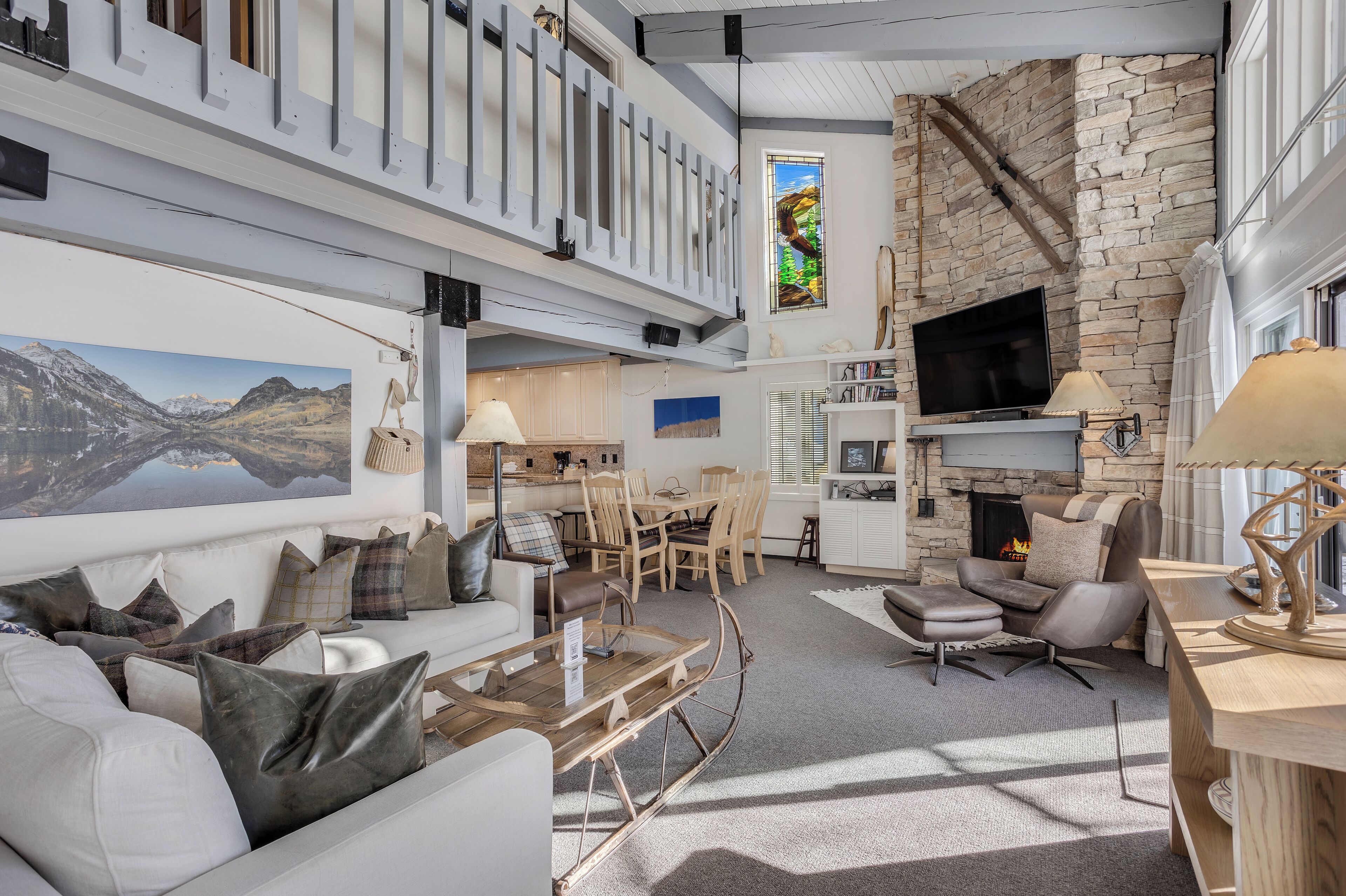 A spacious living area with a fireplace, a dining area, and a kitchen.