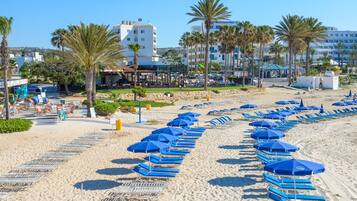 On the beach, sun loungers, beach umbrellas