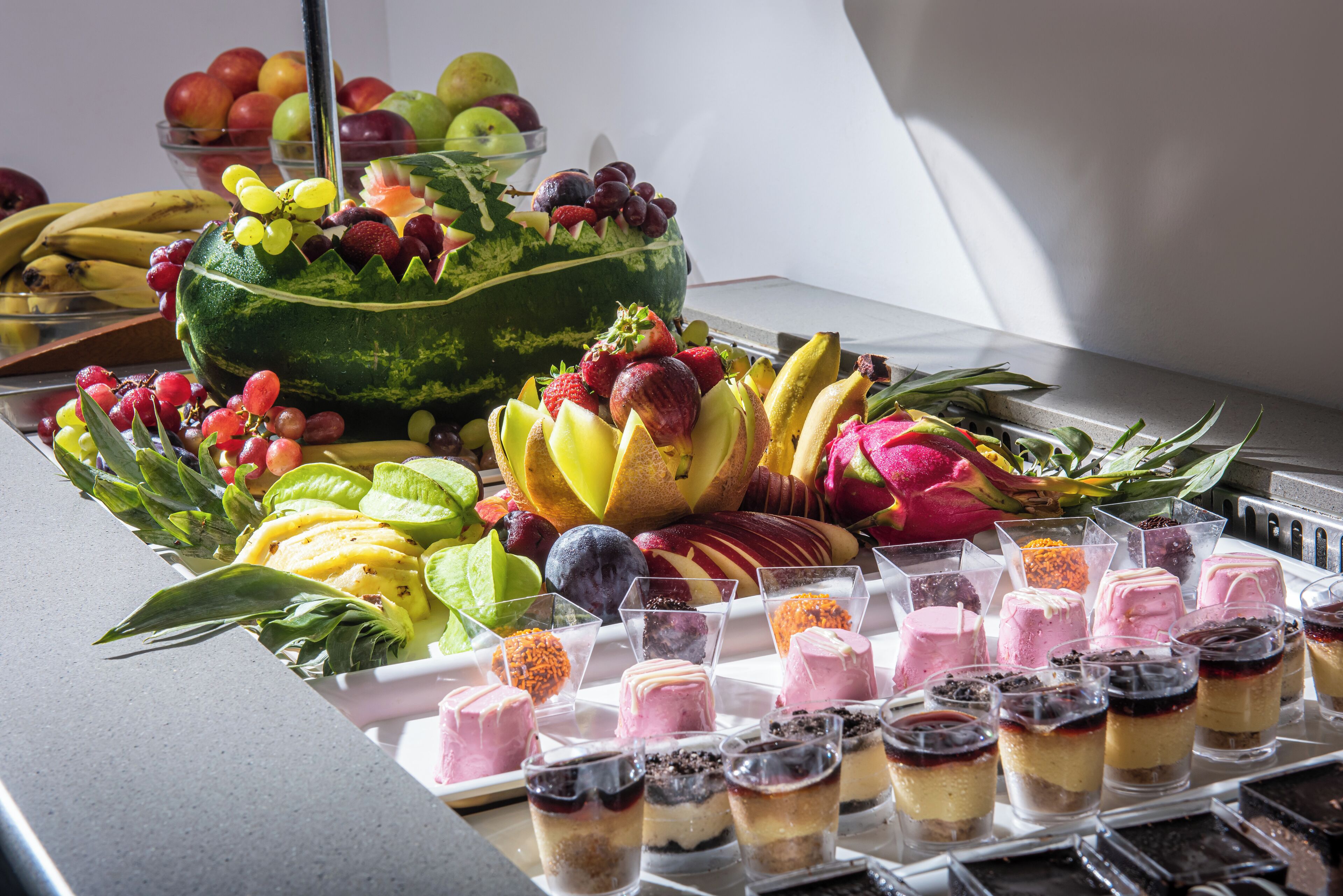 A variety of fruits and desserts on a table.