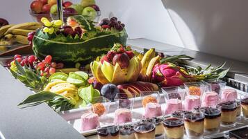 A variety of fruits and desserts on a table.