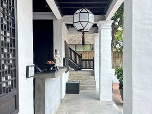 Stroll through this tranquil corridor, lined with traditional lanterns and flanked by elegant columns.